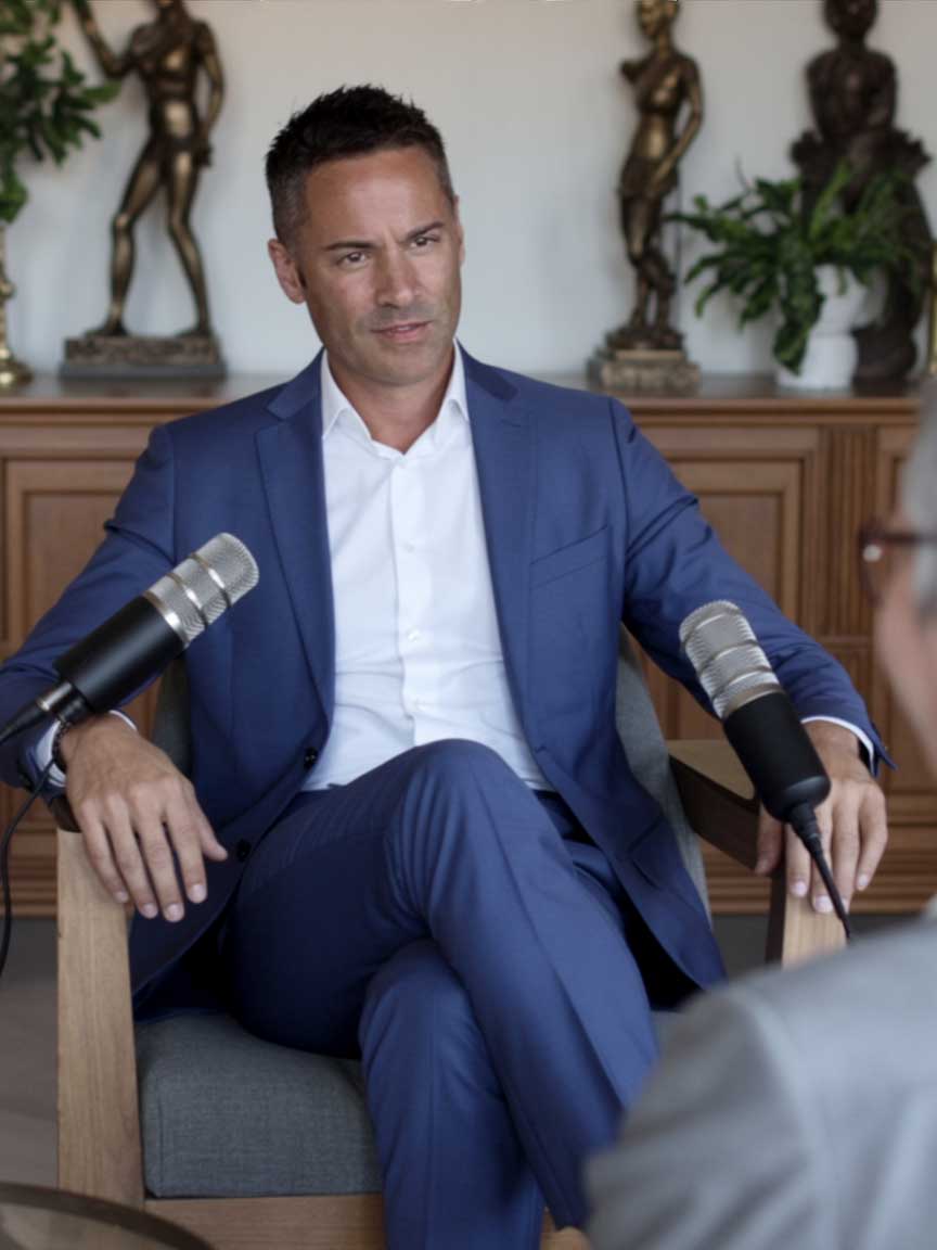 Kenton Gray, CEO of Veracor Group, in professional blue suit on podcast set