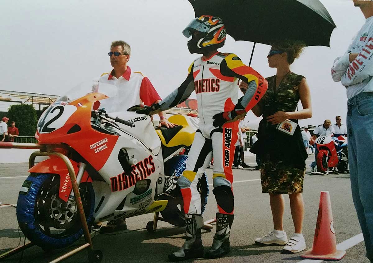 Dianetics #42 motorcycle rider in pit lane at Pocono Raceway with racing team crew