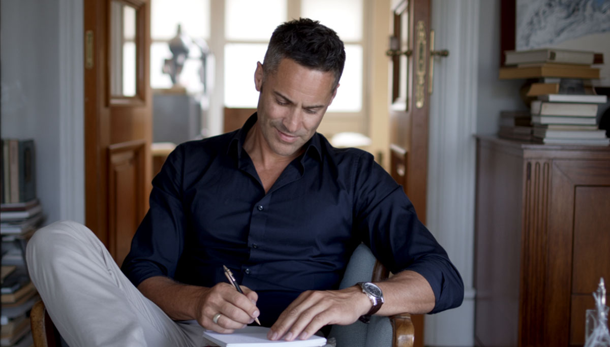 Kenton Gray writing in his study - author and healthcare thought leader